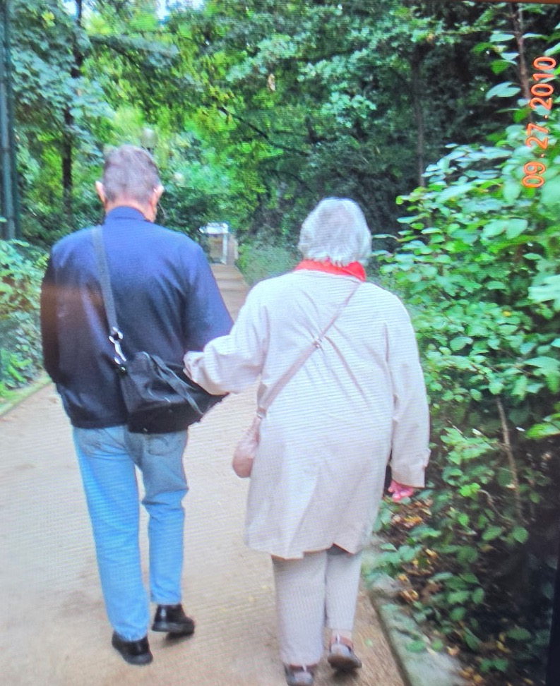 Norman Hill Dyer walking arm in arm with Cynthia Camille Miller Dyer along a wooded path, September 2010.